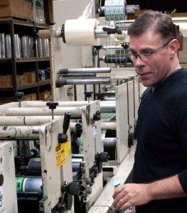 John O'Connor, sole owner of United Label Corporation, manufacturer of custom pressure sensitive labels, checking out one of his machines